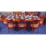 A burr walnut extending dining table in the Regency style, with two leaves, on a double pedestal