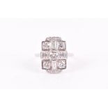 An 18ct white gold and diamond ring in the Art Deco taste, the rectangular crossed mount set with