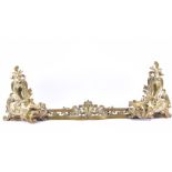An early 20th century Louis XV style brass fire fender with c-scroll Rococo acanthus leaves to