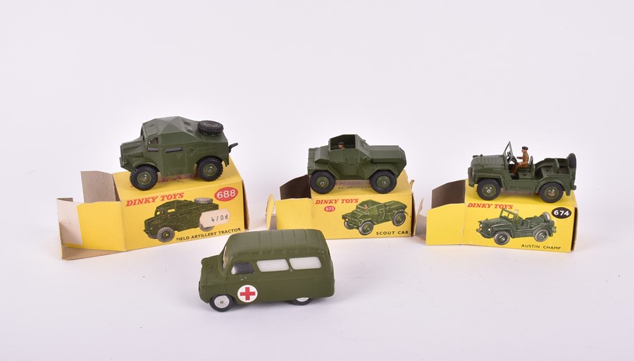 Three Dinky Toys boxed military vehicles comprising a 674 Austin Champ, a 673 Scout Car and a 688