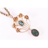 A 9ct yellow gold and turquoise pendant by Murrle Bennett in the Arts and Crafts style, set with a