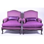 A pair of Roche Bobois armchairs  with wide seats and studded purple upholstery on a Victorian style