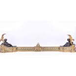 A Louis XV style gilt and patinated bronze fender designed with lying putti holding floral