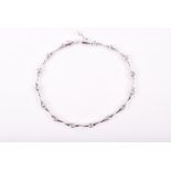A 9ct white gold and diamond line bracelet the fifteen collet-set diamonds alternated with tapered