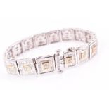 An 18ct white gold and diamond bracelet with square-shaped segments, each with yellow gold square to