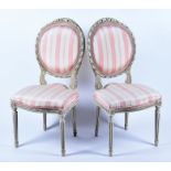 A pair of French Louis XVI style bedroom chairs upholstered with pink stripped fabric, the white