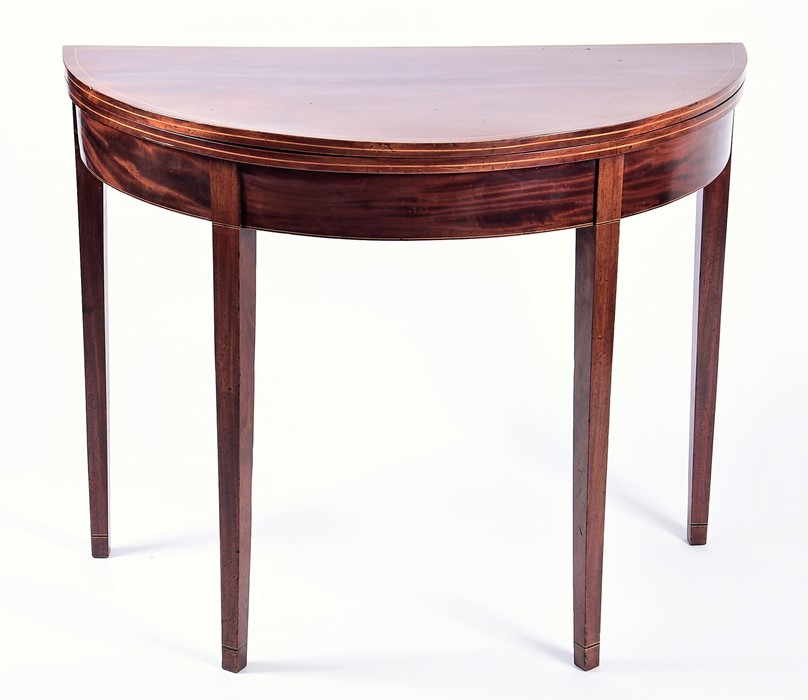 An Edwardian flame mahogany demi-lune card table with satinwood cross banding and baize lined