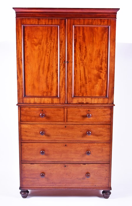 A 19th century mahogany linen press with two cupboard doors over two short and three graduated