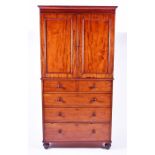 A 19th century mahogany linen press with two cupboard doors over two short and three graduated