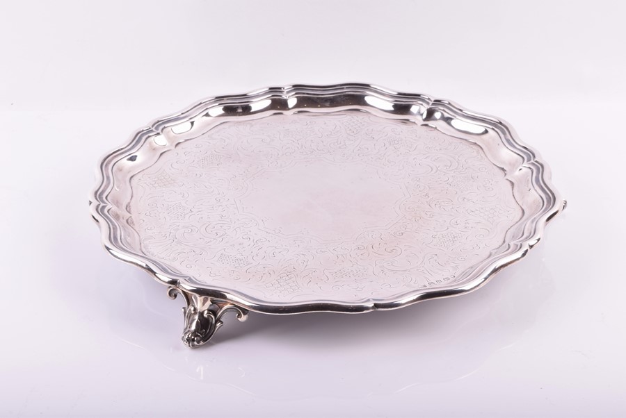 A Victorian silver salver Sheffield 1856, James Dixon and Sons, with scalloped borders, raised on