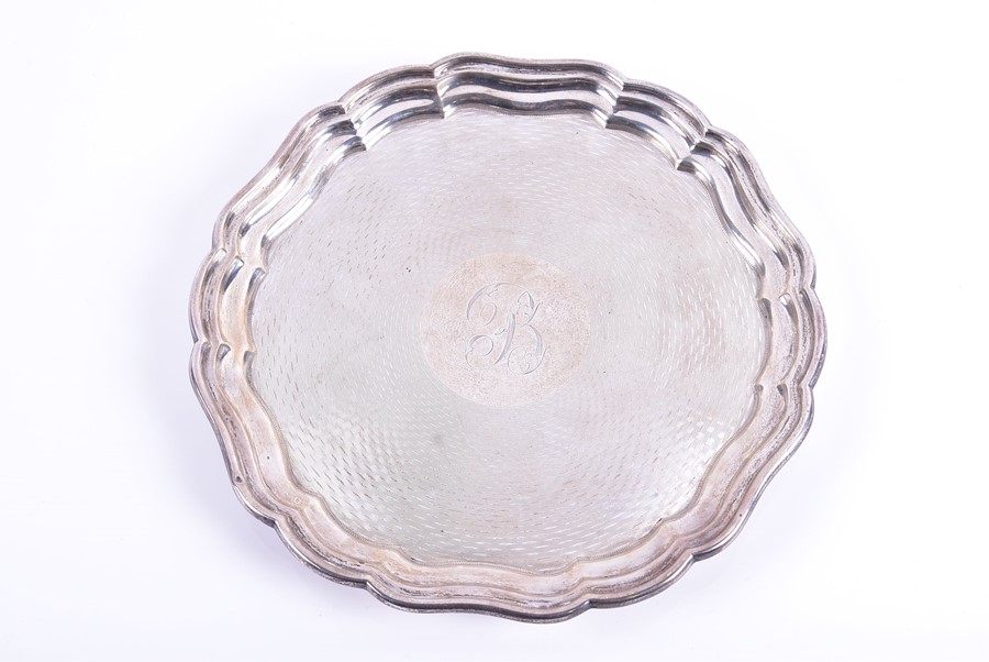 A George V silver salver Birmingham 1922 by Joseph Gloster Ltd. with wavy pie crust shaped rim,