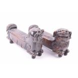 A pair of early Chinese hardwood foo dogs possibly used as scroll weights, the guardians heads sit