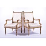 A pair of XVI style gilded fauteuils upholstered with light floral fabric, the frames with gadroon