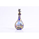 An 18th century South Staffordshire enamel scent bottle painted with landscapes reserved on a blue