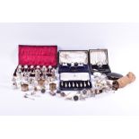 A group of assorted silver and plated items including various cruet sets, some plated, napkin rings,
