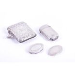 Two silver vesta cases and a miniature pill box the larger vesta decorated with crawling floral work
