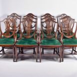 A set of twelve Sheraton style mahogany dining chairs with pierced splat backs and stylised leaf