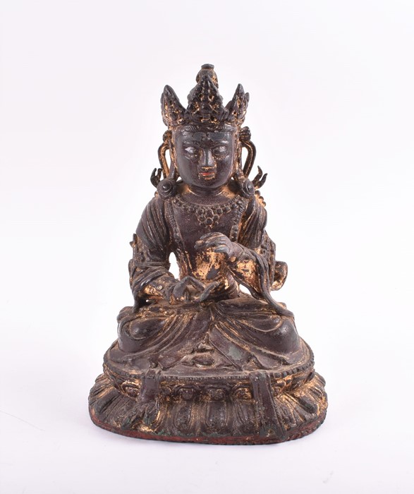 A 19th century or earlier Tibetan gilt bronze sculpture of Padmasambhava modelled seated in