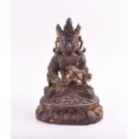 A 19th century or earlier Tibetan gilt bronze sculpture of Padmasambhava modelled seated in
