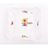 A Meissen porcelain dish  decorated with hand-painted floral sprays on an ivory ground, bearing a