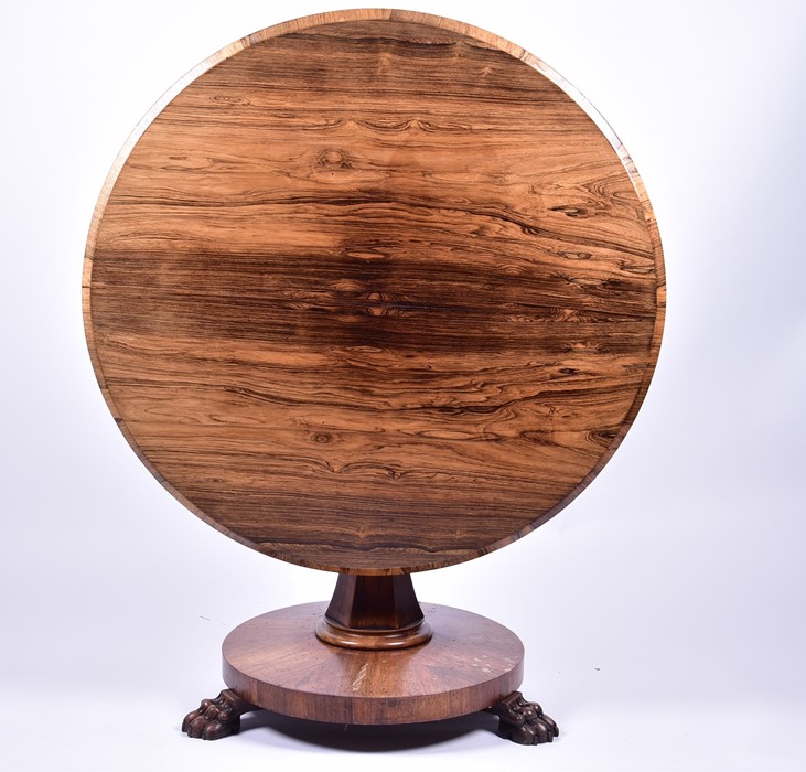 A William IV circular rosewood breakfast table, the circular tilt top with sloped border, set