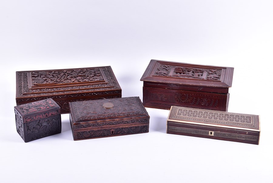 A collection of relief carved hardwood boxes along with one with bone inlay of rectangular form