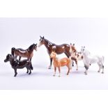 A Beswick Pinto Pony together with a Palomino Pony, a Welsh Mountain Pony and three further