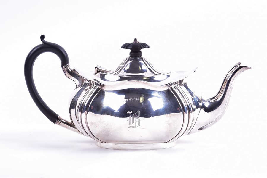 A George V silver teapot Sheffield 1916, by R F Mosley & Co, with lobed shaped body mounted with