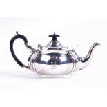 A George V silver teapot Sheffield 1916, by R F Mosley & Co, with lobed shaped body mounted with