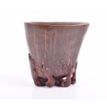 A Chinese carved Rhinoceros horn libation cup the rhino horn of even treacle colour and gently