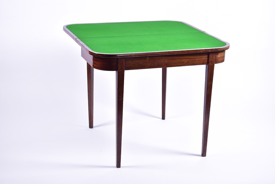 An Edwardian mahogany fold-over card table opening to reveal a green baize, on tapering legs, 90 - Image 2 of 3