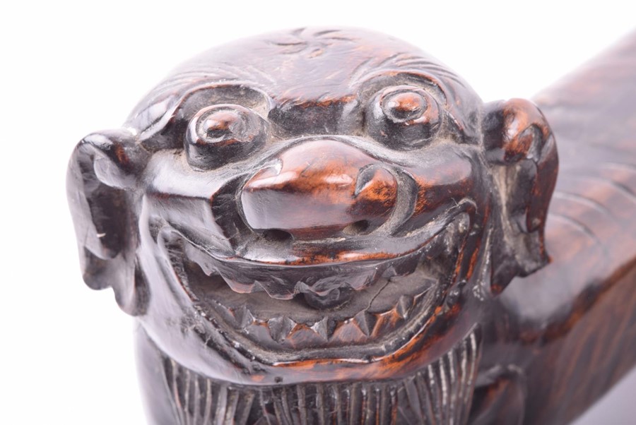 A pair of early Chinese hardwood foo dogs possibly used as scroll weights, the guardians heads sit - Image 3 of 6