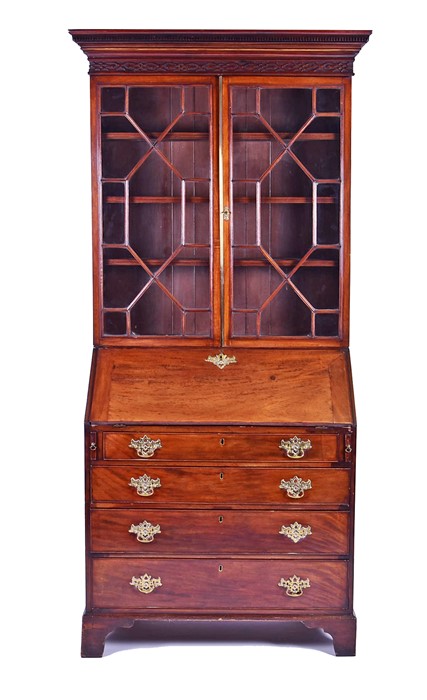 A George III mahogany bureau bookcase with carved frieze over twin astral glazed doors, the drop