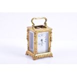 A miniature French carriage clock  late 19th century, encased in a cast brass body, surmounted by
