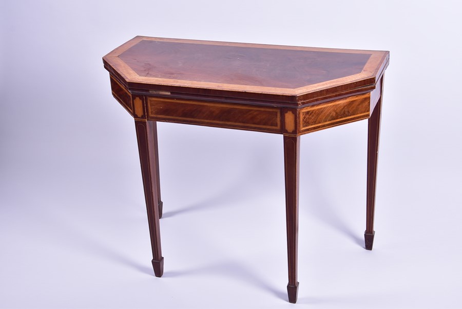 A Georgian mahogany card table with satinwood and tulipwood veneers a hexagonal shaped top, with