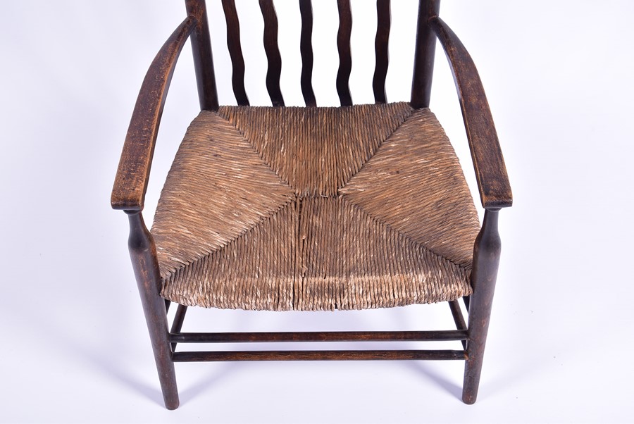 A 19th century rush seated low carver chair in the Arts and Crafts style, the seat 30 cm high. - Image 2 of 4