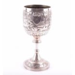 A late 19th century North Indian silver goblet with embossed decoration depicting villagers at work,