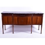 An Adam style marble top sideboard of serpentine form with reeded frieze designed with central urn