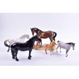 A Beswick 1516 Appaloosa Walking Pony together with a 953 Mare and Foal figure group and three