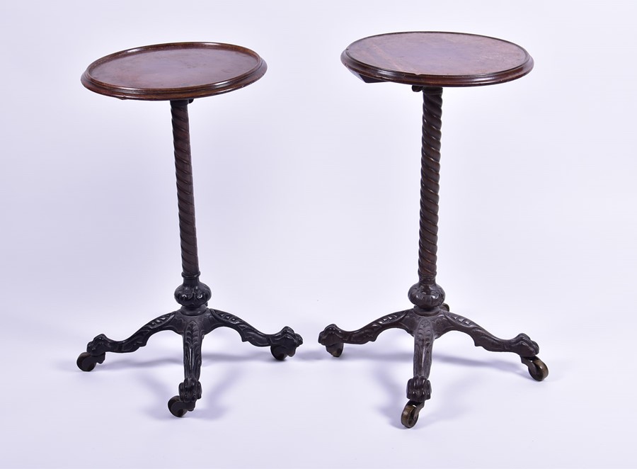 A near pair of Victorian occasional tables both with circular mahogany tops with adjustable columns,