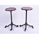 A near pair of Victorian occasional tables both with circular mahogany tops with adjustable columns,