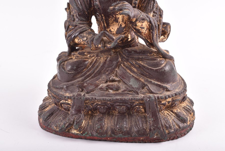 A 19th century or earlier Tibetan gilt bronze sculpture of Padmasambhava modelled seated in - Image 4 of 10