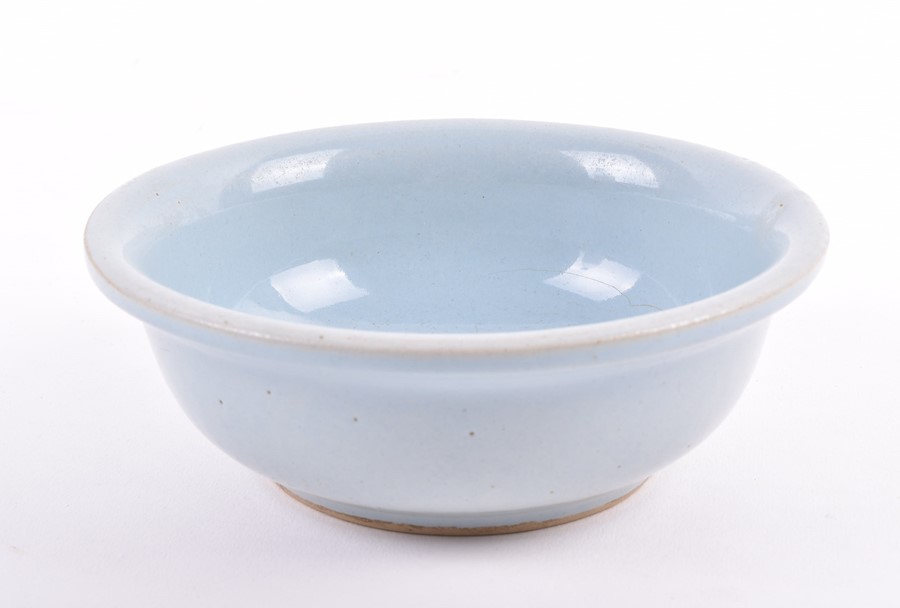 A Chinese powder blue bowl possibly Song dynasty, of even powder blue colour, with some pitting to