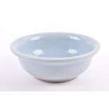 A Chinese powder blue bowl possibly Song dynasty, of even powder blue colour, with some pitting to