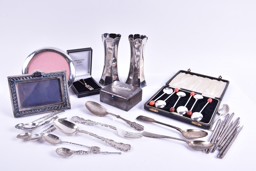 A small group of assorted silver items including a pair of posy vases, assorted coffee spoons,