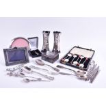 A small group of assorted silver items including a pair of posy vases, assorted coffee spoons,