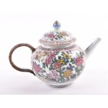 A Chinese Kangxi period or later porcelain teapot and cover later painted in polychrome colours with