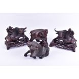 A pair of Chinese carved hardwood 'Buffalo and child' models with textured detail to the buffalos,