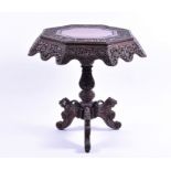 A 19th century Anglo-Indian carved hardwood centre table the octagonal tip with plain centre and