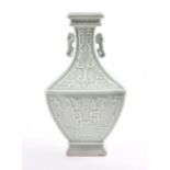 A Chinese porcelain Qianlong period Celadon vase of square form, the body embossed with symbols